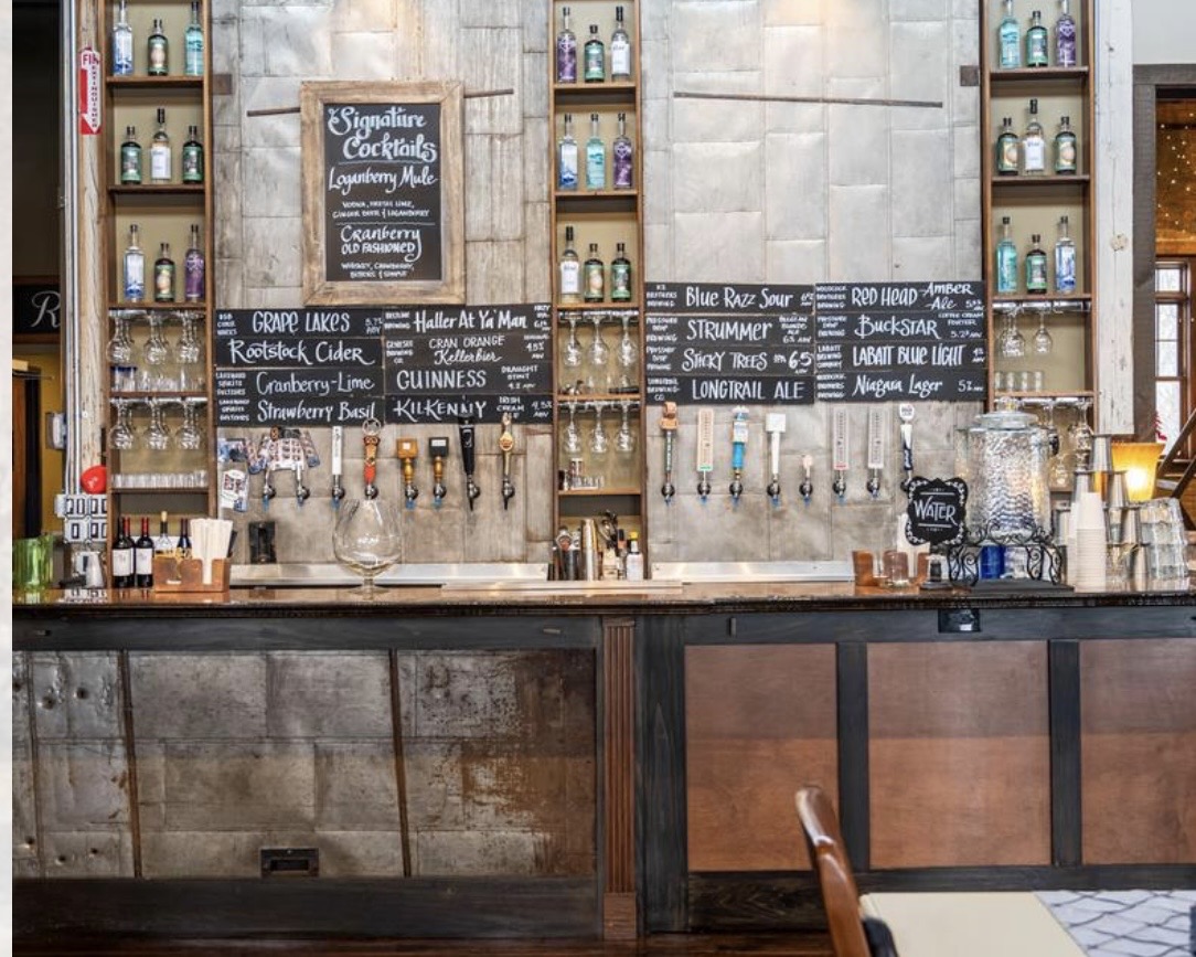 The Barrel Factory bar, with beer taps, bottle displays, and chalkboard drink menus